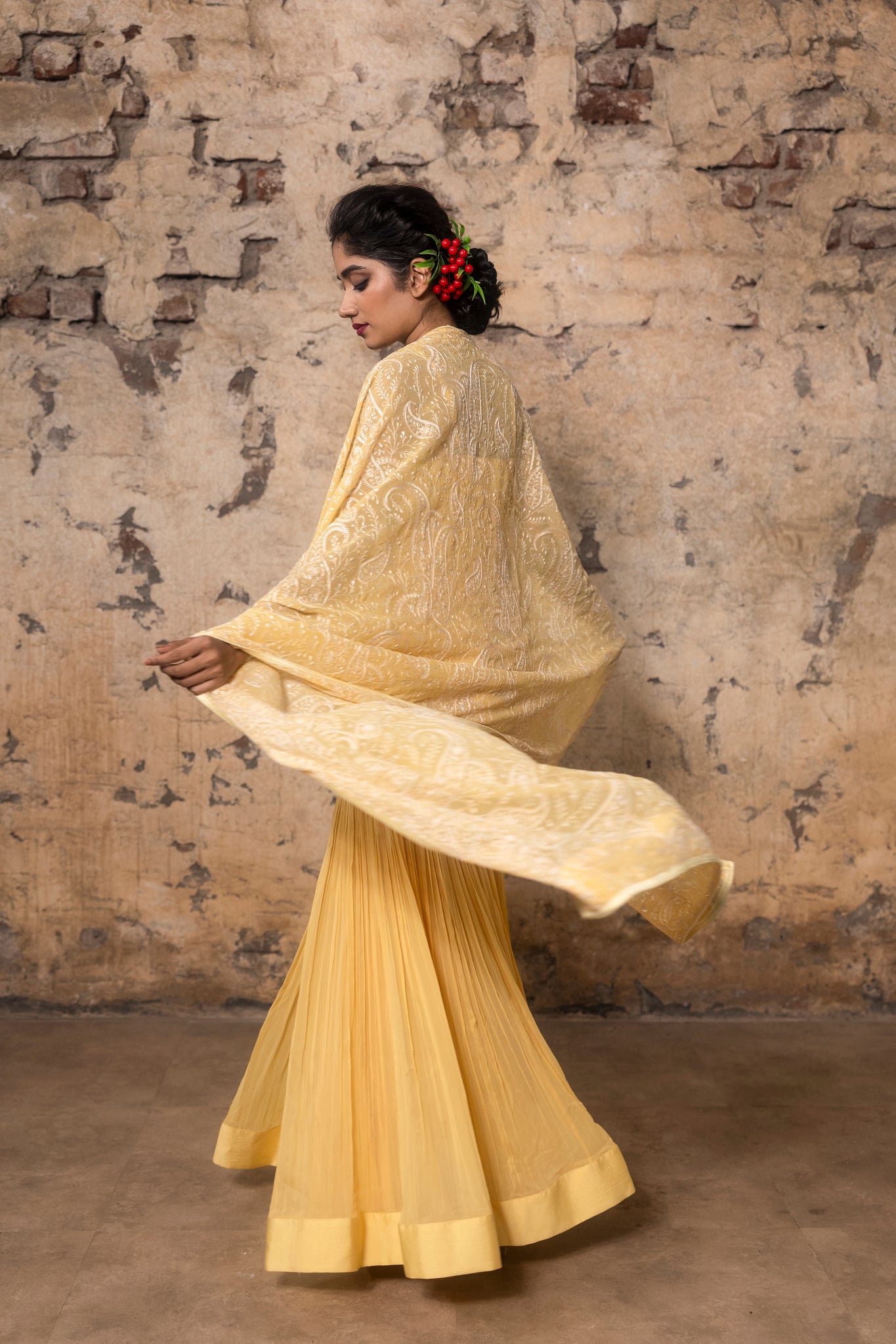 Yellow pleated sharara paired with peplum top and embroidered dupatta